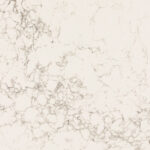 A smooth, cream-colored surface displays a pattern of delicate, light gray veining resembling marble, creating an elegant and sophisticated appearance.