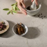 Caesarstone Porcelain 545_Fossillia surface with hands working with spices